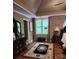 This is the main bedroom featuring a ceiling fan, hardwood floors, and a large window at 3930 Regal Oaks Dr, Suwanee, GA 30024