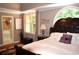 Main bedroom features a large bed, natural light, and an entrance to the ensuite bathroom at 3930 Regal Oaks Dr, Suwanee, GA 30024