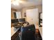 Spacious home office featuring hardwood floors, large desk, and a black office chair at 3930 Regal Oaks Dr, Suwanee, GA 30024