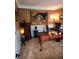 Cozy office with tan walls, carpeted floors, wood desk, and tapestry at 3930 Regal Oaks Dr, Suwanee, GA 30024
