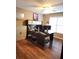 Bright home office featuring hardwood floors, desk with computers, and a storage cabinet at 3930 Regal Oaks Dr, Suwanee, GA 30024