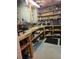 Unfinished basement storage room with workbench, tool organizers, and open shelving at 3930 Regal Oaks Dr, Suwanee, GA 30024