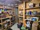 Unfinished basement storage room with shelving full of supplies and miscellaneous items at 3930 Regal Oaks Dr, Suwanee, GA 30024