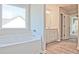 Bathroom featuring a soaking tub, wood-look floors, and large window at 1436 Weeping Tree Dr, Auburn, GA 30011