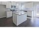 Modern kitchen featuring granite countertops, stainless steel appliances, and a center island with dark wood flooring at 1436 Weeping Tree Dr, Auburn, GA 30011