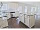 Stylish kitchen with granite counters, stainless appliances, and island with seating overlooking the living area at 1436 Weeping Tree Dr, Auburn, GA 30011