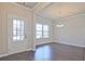 Bright living room with a front door, complemented by hardwood floors and contemporary lighting fixtures at 1436 Weeping Tree Dr, Auburn, GA 30011
