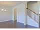 Open-concept living room boasting hardwood floors and neutral walls, seamlessly connected to other areas at 1436 Weeping Tree Dr, Auburn, GA 30011