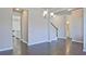 Spacious living room with an open layout, showcasing hardwood floors and seamless transitions to other living spaces at 1436 Weeping Tree Dr, Auburn, GA 30011
