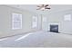 Bright living room featuring a cozy fireplace and multiple windows, offering ample natural light at 1436 Weeping Tree Dr, Auburn, GA 30011