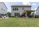 Spacious backyard features a lush green lawn, a cozy seating area, and a covered patio, perfect for entertaining and relaxation at 2099 Lakeview Bend Way, Buford, GA 30519