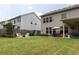 Expansive backyard with seating area, lush green lawn, and a private fence, offering a perfect blend of relaxation and recreation at 2099 Lakeview Bend Way, Buford, GA 30519