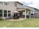 Spacious backyard featuring a covered patio, seating area, and lush green lawn, perfect for outdoor entertaining at 2099 Lakeview Bend Way, Buford, GA 30519