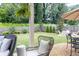 Serene backyard featuring lush green lawn, a wooden fence, and cozy seating area to relax and enjoy the outdoors at 2099 Lakeview Bend Way, Buford, GA 30519