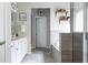 Stylish bathroom featuring double vanity sinks, marble countertops, and a glass-enclosed shower and bathtub at 2099 Lakeview Bend Way, Buford, GA 30519