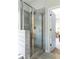 Bathroom boasts a modern glass enclosed shower with gray tile and stylish shower head at 2099 Lakeview Bend Way, Buford, GA 30519