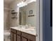 Well-lit bathroom showcasing a vanity with dual sinks, neutral tile, and coordinated fixtures at 2099 Lakeview Bend Way, Buford, GA 30519