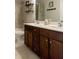 Bathroom showcasing a dual sink vanity, tile floors, and coordinated fixtures at 2099 Lakeview Bend Way, Buford, GA 30519