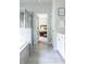 Light-filled bathroom with tiled floors, glass shower, and adjacent bedroom entrance at 2099 Lakeview Bend Way, Buford, GA 30519