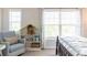 Bedroom with a comfortable chair, decorative pillows, and a built-in bookshelf at 2099 Lakeview Bend Way, Buford, GA 30519