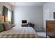 Bedroom featuring a comfortable bed, desk area, and large dresser at 2099 Lakeview Bend Way, Buford, GA 30519