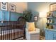 Beautiful Bedroom with a wooden crib, comfortable chair, and charming decor at 2099 Lakeview Bend Way, Buford, GA 30519