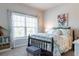 Inviting bedroom with a comfortable bed, large window, and charming decorative accents at 2099 Lakeview Bend Way, Buford, GA 30519