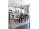 Elegant dining area with modern lighting, a wooden table with neutral dining chairs, and kitchen views at 2099 Lakeview Bend Way, Buford, GA 30519
