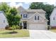Inviting two-story home featuring brick and siding accents, a two-car garage, and a manicured lawn at 2099 Lakeview Bend Way, Buford, GA 30519