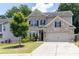 Charming two-story brick home with well-maintained landscaping and a two-car garage at 2099 Lakeview Bend Way, Buford, GA 30519