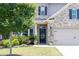 Close-up of the home's entryway, featuring a decorative door and well-kept landscaping at 2099 Lakeview Bend Way, Buford, GA 30519