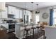 Bright kitchen featuring white cabinets, a granite island, stainless steel appliances, and hardwood floors at 2099 Lakeview Bend Way, Buford, GA 30519