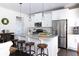 Bright kitchen featuring white cabinetry, granite counters, a stainless steel refrigerator and a center island at 2099 Lakeview Bend Way, Buford, GA 30519