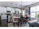 Charming kitchen with white cabinetry, modern appliances, and a dining area perfect for Gathering meals and entertaining at 2099 Lakeview Bend Way, Buford, GA 30519