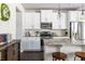 Well-lit kitchen with white cabinets, stainless steel appliances, and a granite countertop island at 2099 Lakeview Bend Way, Buford, GA 30519