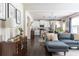 Bright living room with an open floor plan leading to the kitchen and dining area for seamless entertaining at 2099 Lakeview Bend Way, Buford, GA 30519