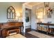 Elegant living room features hardwood floors, a decorative console table, and a piano at 2099 Lakeview Bend Way, Buford, GA 30519