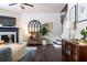 Cozy living room with a fireplace, comfortable seating, and stylish decor, perfect for relaxing and entertaining guests at 2099 Lakeview Bend Way, Buford, GA 30519