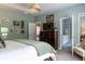 Main bedroom featuring a large dresser, television, and view into the ensuite bathroom at 2099 Lakeview Bend Way, Buford, GA 30519