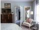 Main bedroom featuring a comfy chair and a view into the ensuite bathroom with walk-in closet at 2099 Lakeview Bend Way, Buford, GA 30519