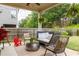 Cozy covered outdoor patio featuring stylish seating, a grill, and a ceiling fan for comfortable outdoor living at 2099 Lakeview Bend Way, Buford, GA 30519