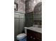 Stylish powder room features a floral wallpaper accent, wainscoting, and a marble countertop at 2099 Lakeview Bend Way, Buford, GA 30519