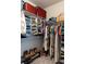 Organized walk-in closet with shelves for shoes, folded clothes, and hanging items at 2099 Lakeview Bend Way, Buford, GA 30519