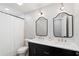Modern bathroom features a dual sink vanity with black cabinets, gold hardware, and a white shower curtain at 3581 Ridge Se Rd, Smyrna, GA 30080