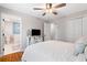 Bedroom with hardwood floors, a ceiling fan, a white dresser, and two closets at 3581 Ridge Se Rd, Smyrna, GA 30080