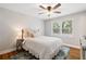 Bright bedroom features a ceiling fan, hardwood floors, and two windows letting in natural light at 3581 Ridge Se Rd, Smyrna, GA 30080