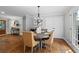 Dining room with seating for six, complemented by modern chandelier and views of the backyard at 3581 Ridge Se Rd, Smyrna, GA 30080