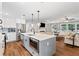Beautiful kitchen island with seating and stainless steel appliances offering views to living room at 3581 Ridge Se Rd, Smyrna, GA 30080