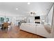 Open-concept living room with fireplace and hardwood floors, connected to a dining room and a kitchen at 3581 Ridge Se Rd, Smyrna, GA 30080
