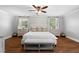 Bright main bedroom with hardwood floors, matching nightstands, lamps, and a bench at 3581 Ridge Se Rd, Smyrna, GA 30080